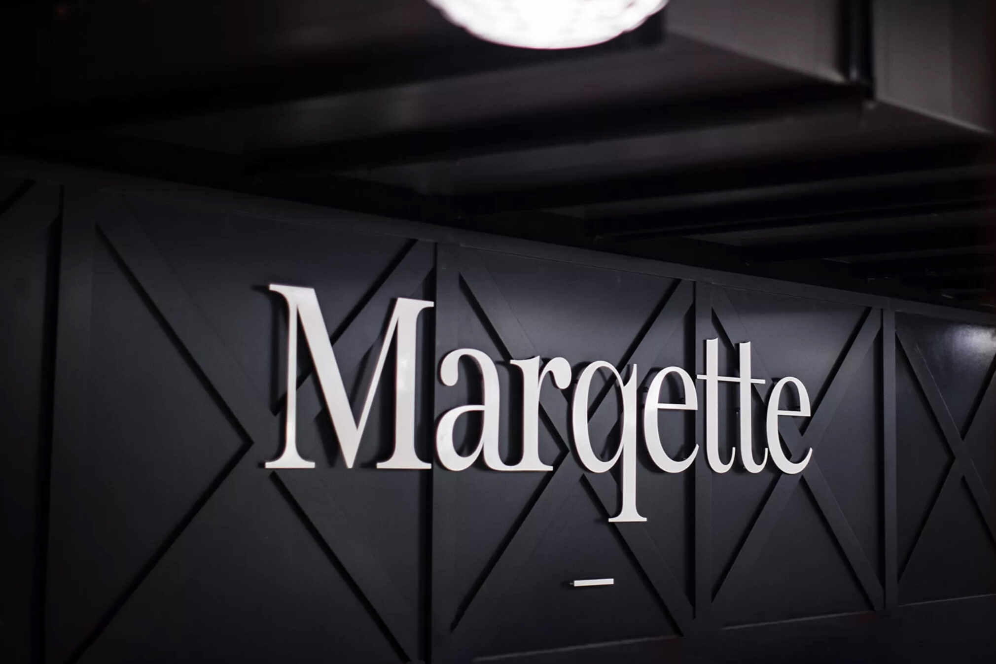 Marqette white wall sign